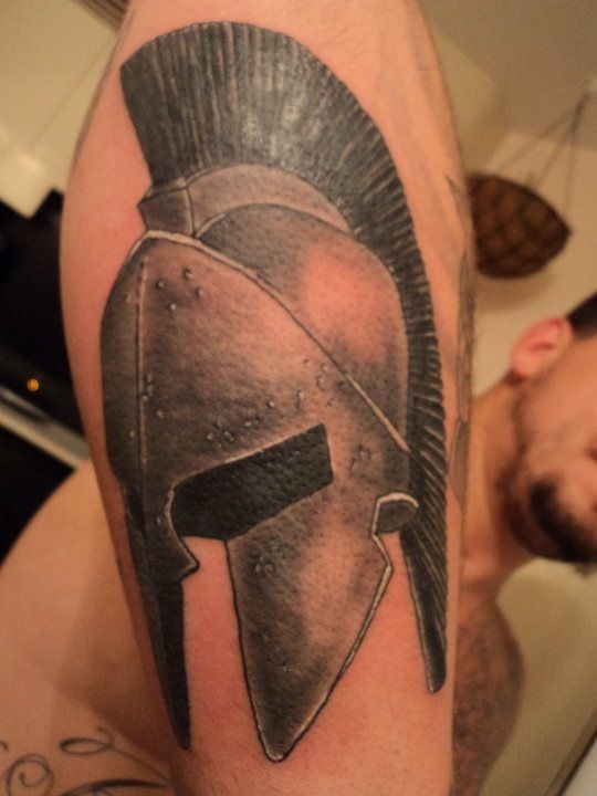 Black And Grey Achilles Mask Tattoo On Arm