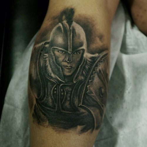 Black Ink Achilles Tattoo On Forearm