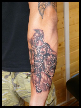 Black Ink Achilles Warrior Tattoo On Forearm