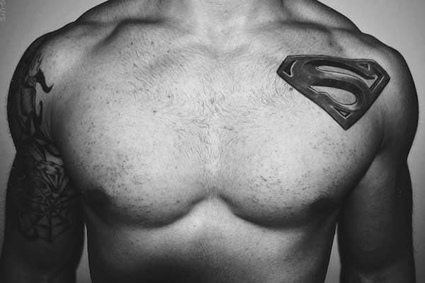 Black Ink Superman Logo Tattoo On Man Left Front Shoulder