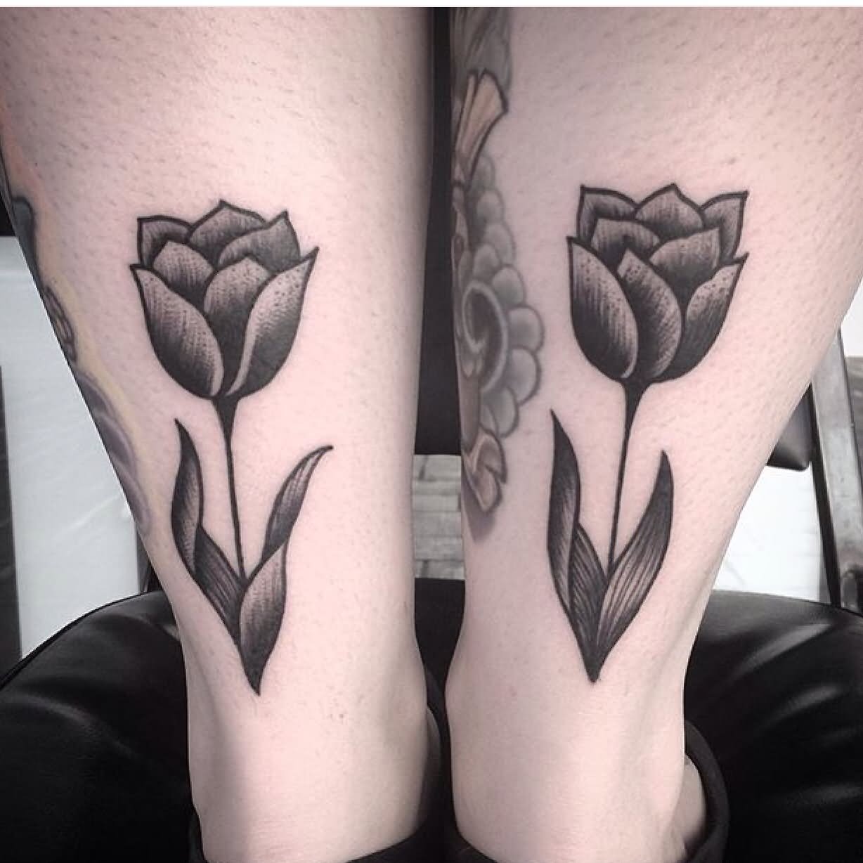 Black Ink Tulip Flower Tattoo On Achilles