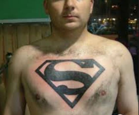 Black Superman Logo Tattoo On Man Chest