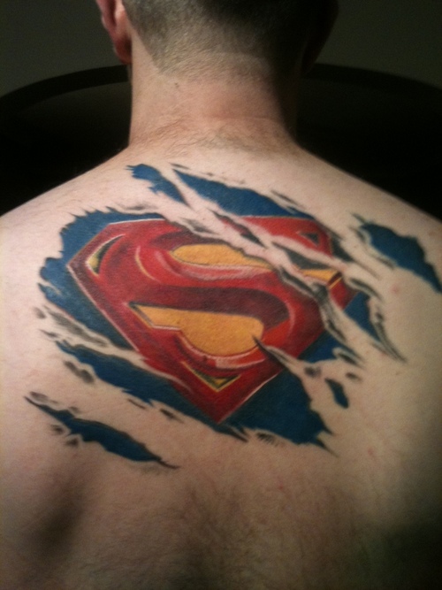 Colorful Ripped Skin Logo Tattoo On Man Upper Back