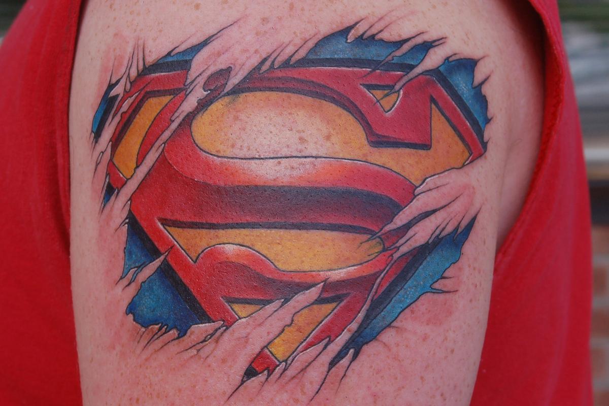 Colorful Ripped Skin Superman Logo Tattoo Design For Shoulder.