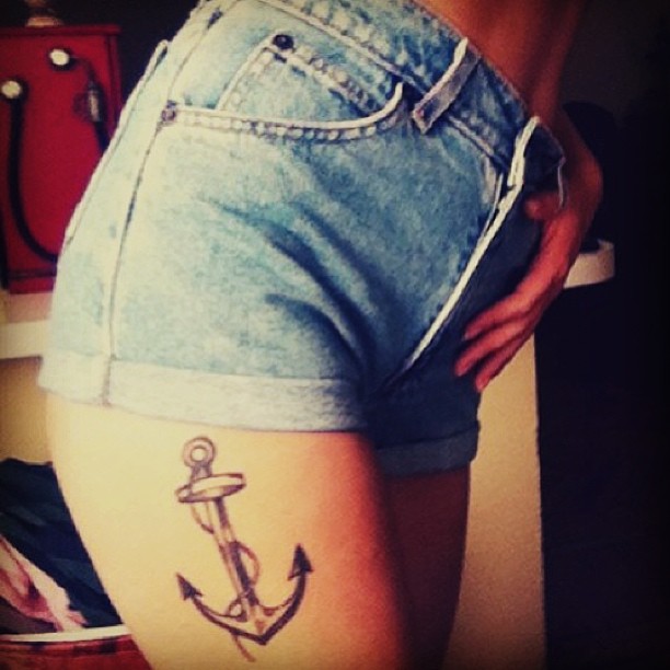 Grey Ink Anchor Tattoo On Girl Side Thigh