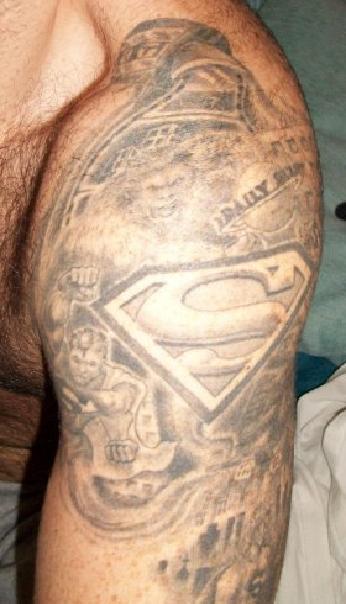 Grey Ink Superman Logo Tattoo On Man Left Shoulder