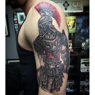 Red And Black Achilles Tattoo On Man Left Half Sleeve