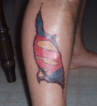 Ripped Skin Superman Logo Tattoo On Leg