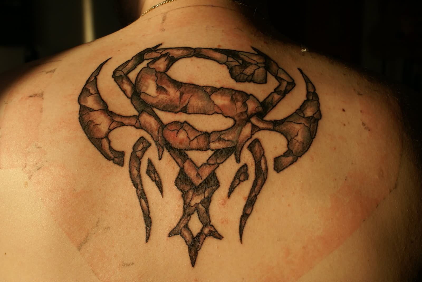 Stone Superman Logo Tattoo On Man Upper Back By Tredje