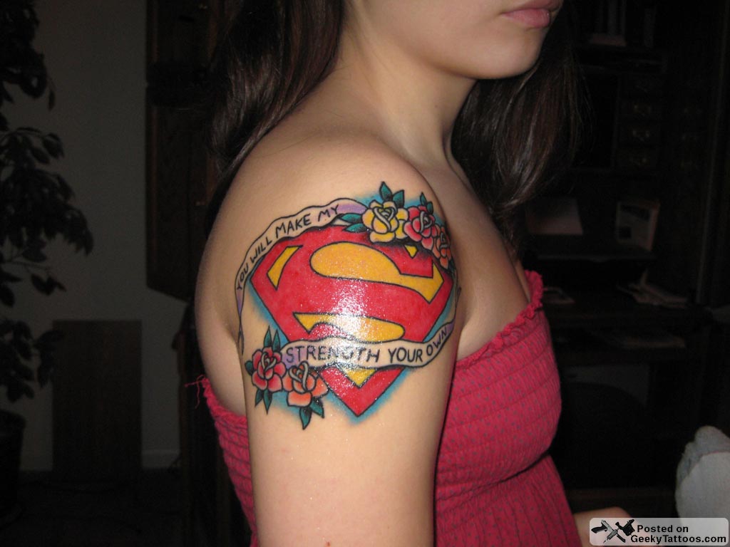 Superman Logo With Banner And Flowers Tattoo On Girl Right Shoulder