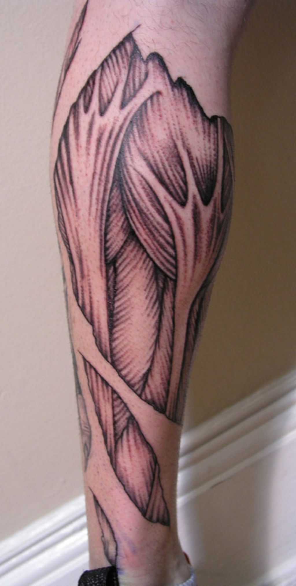 Attractive Ripped Skin Muscle Tattoo Design For Leg