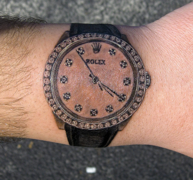 Attractive Wrist Watch Tattoo On Upper Wrist