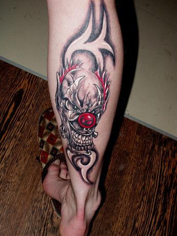 Awesome Black And Red Clown Head Tattoo On Leg