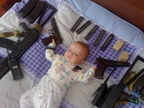 Baby With Guns Funny Image