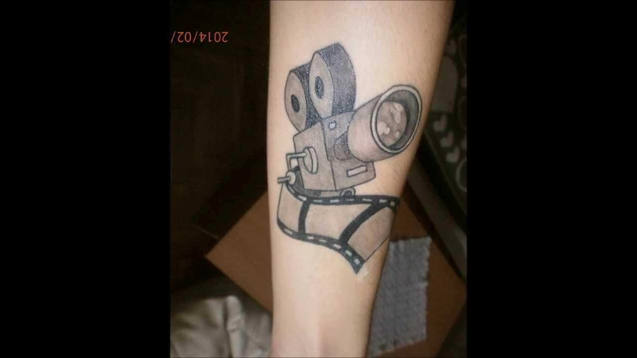Black And Grey 3D Movie Camera With Reel Tattoo On Forearm