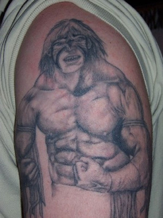 Black And Grey Kane Wrestler Tattoo On Half Sleeve