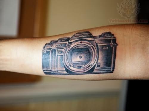 Black And Grey Movie Camera Tattoo On Forearm
