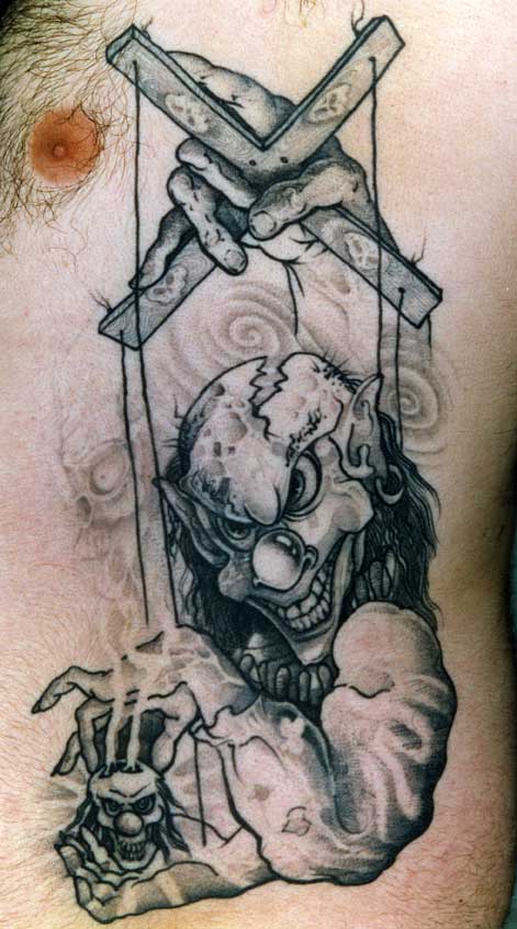 Black And Grey Puppet Clown Tattoo On Side Rib