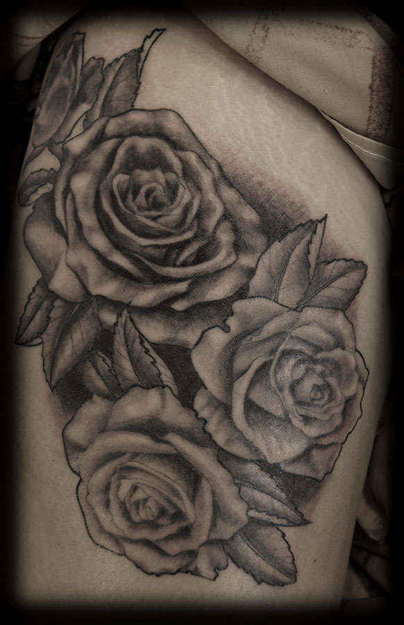 Black And Grey Rose Flowers Tattoo On Thigh