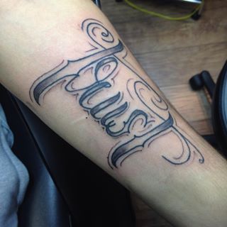 Black And Grey Trust Tattoo On Forearm