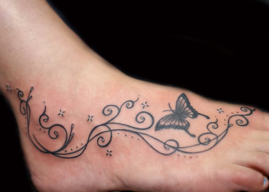 Black Butterfly With Swirl Tattoo On Girl Foot.