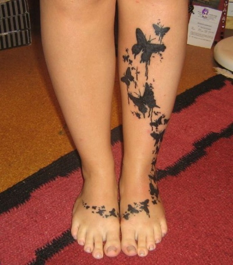 Black Flying Butterflies Tattoo On Feet And Leg