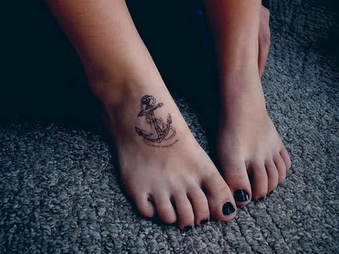 Black Ink Anchor Tattoo On Girl Foot
