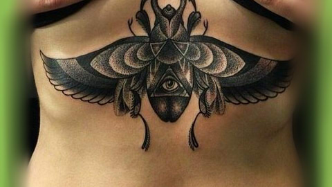 Black Ink Beetle Tattoo On Under Breast