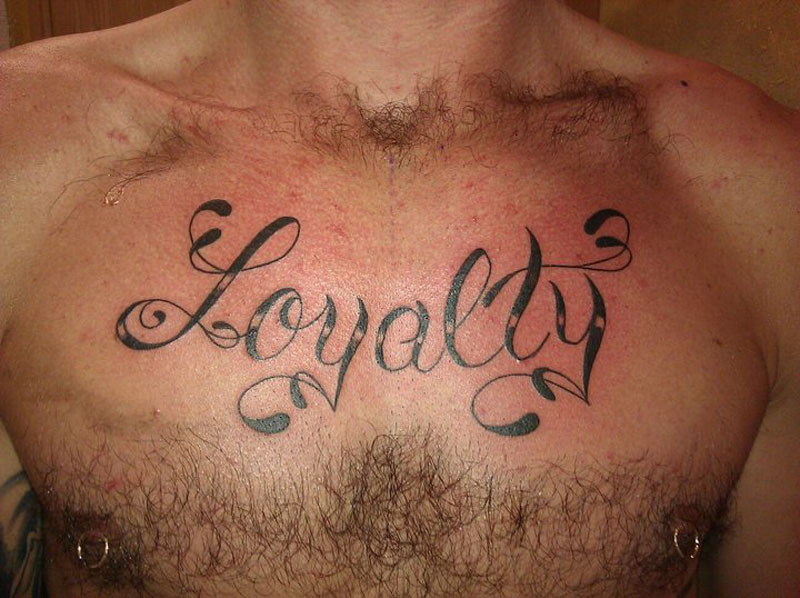 Black Ink Loyalty Tattoo On Man Chest