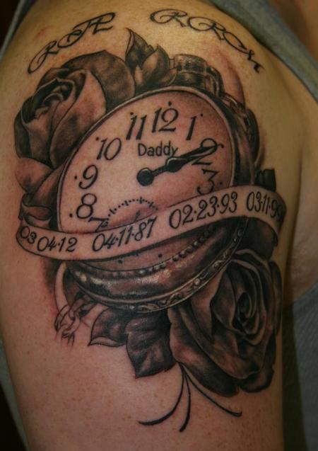 Black Ink Watch With Roses And Banner Tattoo On Shoulder