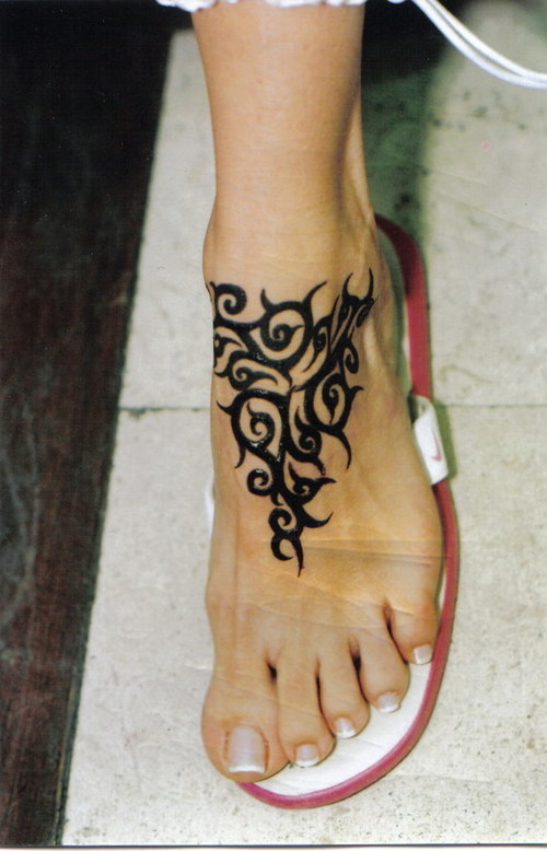 Black Tribal Design Tattoo On Foot