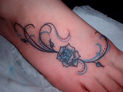 Blue And Black Flower Tattoo On Foot