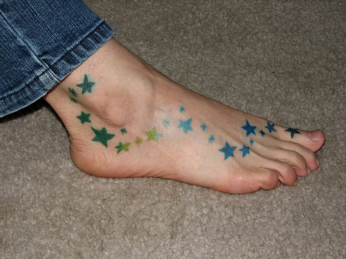 Blue And Green Stars Tattoo On Foot