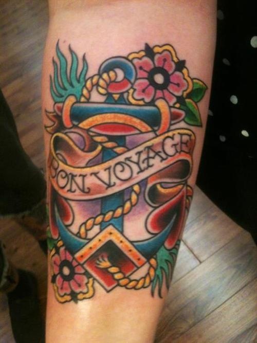 Bon Voyage Banner And Traditional Anchor Tattoo On Arm