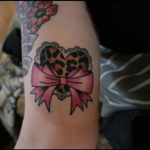 Bow And Cheetah Print Heart Tattoo On Bicep