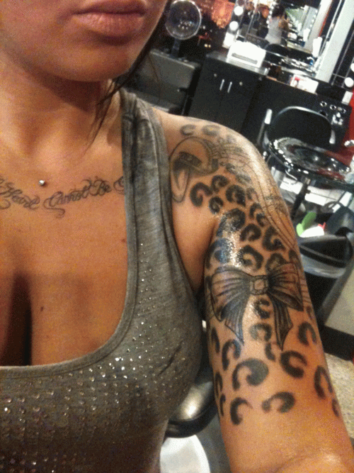 Bow And Cheetah Print Tattoo On Left Half Sleeve