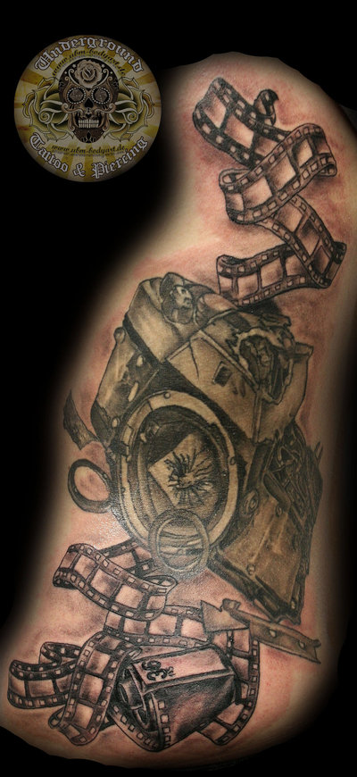 Broken Movie Camera With Reel Tattoo Design By 2Face