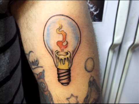 Burning Candle In Bulb Tattoo On Man Left Arm