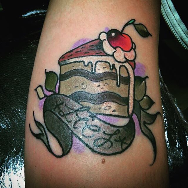 Cake Piece With Banner Tattoo Design For Arm