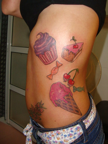 Cake Piece With Cupcake And Softy Tattoo On Side Rib