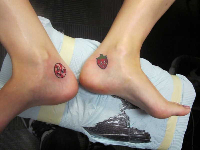 Candy And Strawberry Tattoo On Feet