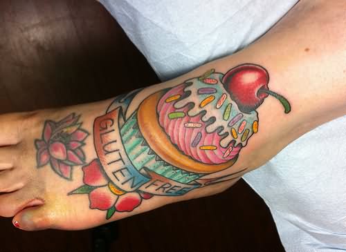 Cherry Cupcake With Banner And Flowers Tattoo On Foot