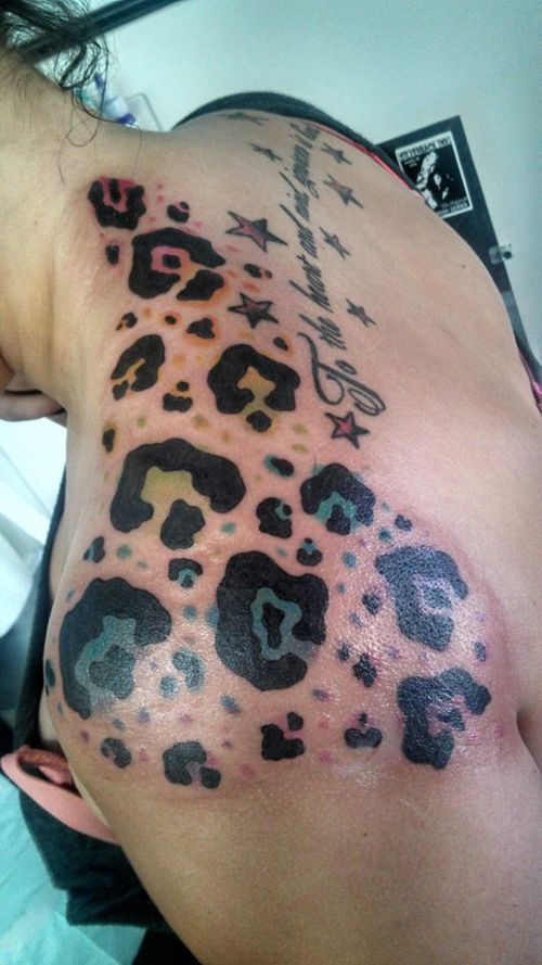 Colored Cheetah Print Tattoo On Upper Back