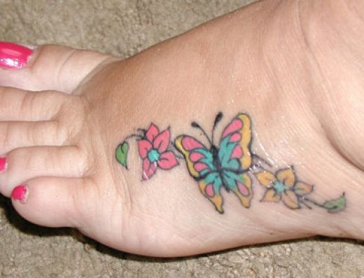 Colorful Butterfly With Flowers Tattoo On Girl Foot