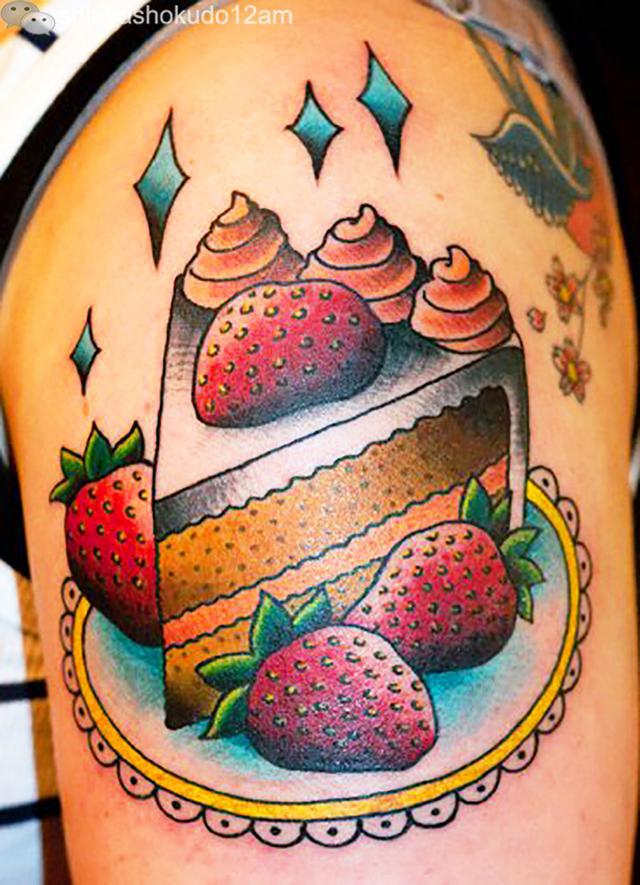 Colorful Cake Piece With Strawberries Tattoo On Left Shoulder