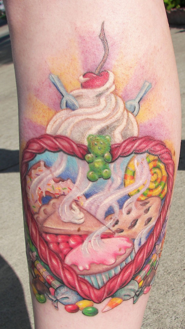 Colorful Cakes In Heart Frame Tattoo Design For Arm