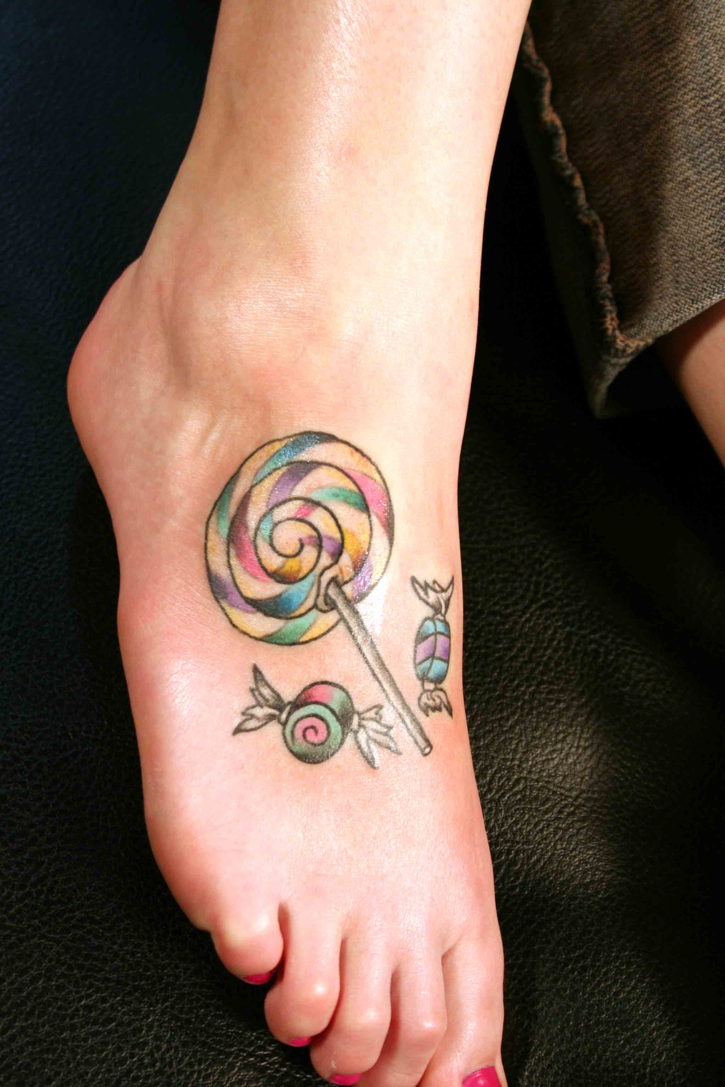 Colorful Candies Tattoo On Girl Foot