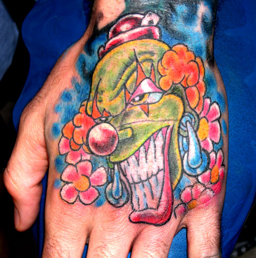 Colorful Clown Head With Flowers Tattoo On Hand By Timebomb613