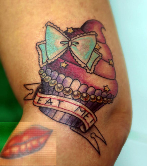Colorful Cupcake With Bow And Banner Tattoo Design For Arm
