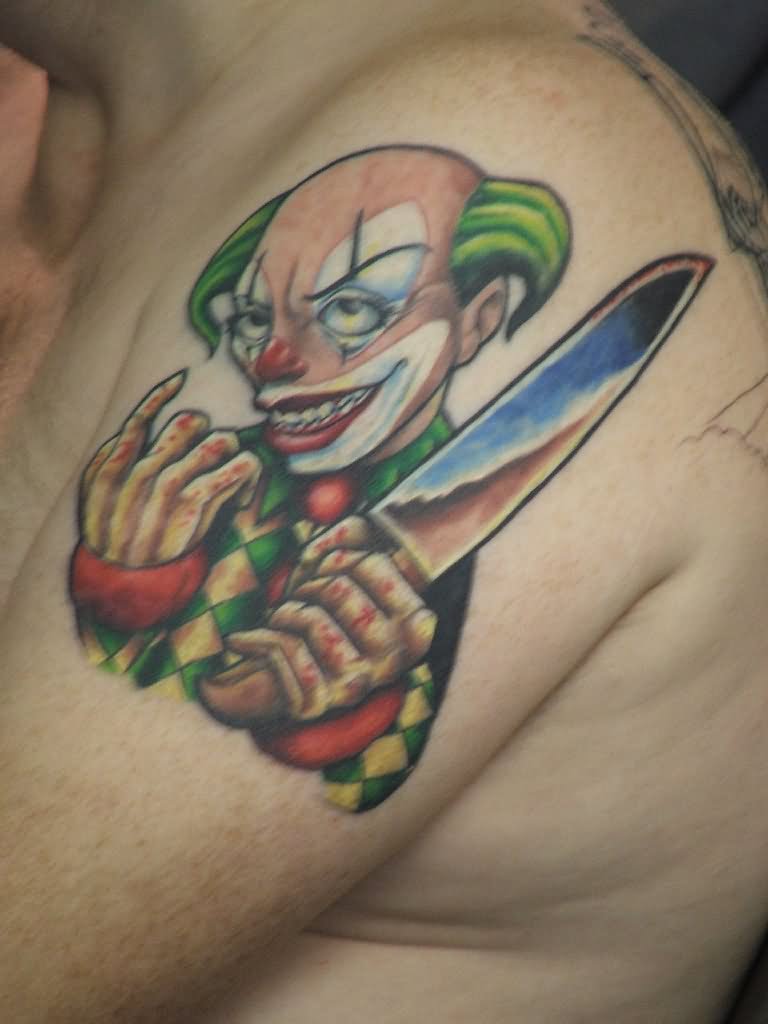 Colorful Knife In Clown Hand Tattoo On Man Left Shoulder
